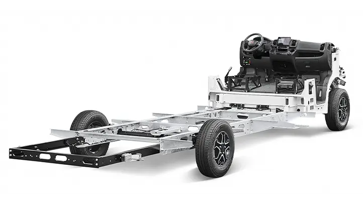 A bare Fiat Ducato motorhome chassis with two front wheels, an exposed frame and a dashboard with steering wheel and controls, viewed from an angle against a white background. It doesn’t have any body parts or rear wheels.