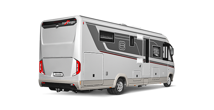 Ein modernes, silbernes Wohnmobil mit schwarzen und roten Details ist auf einem weißen Hintergrund geparkt, von hinten und von der Seite gesehen. Das Fahrzeug hat mehrere Fenster und Außenstaufächer.